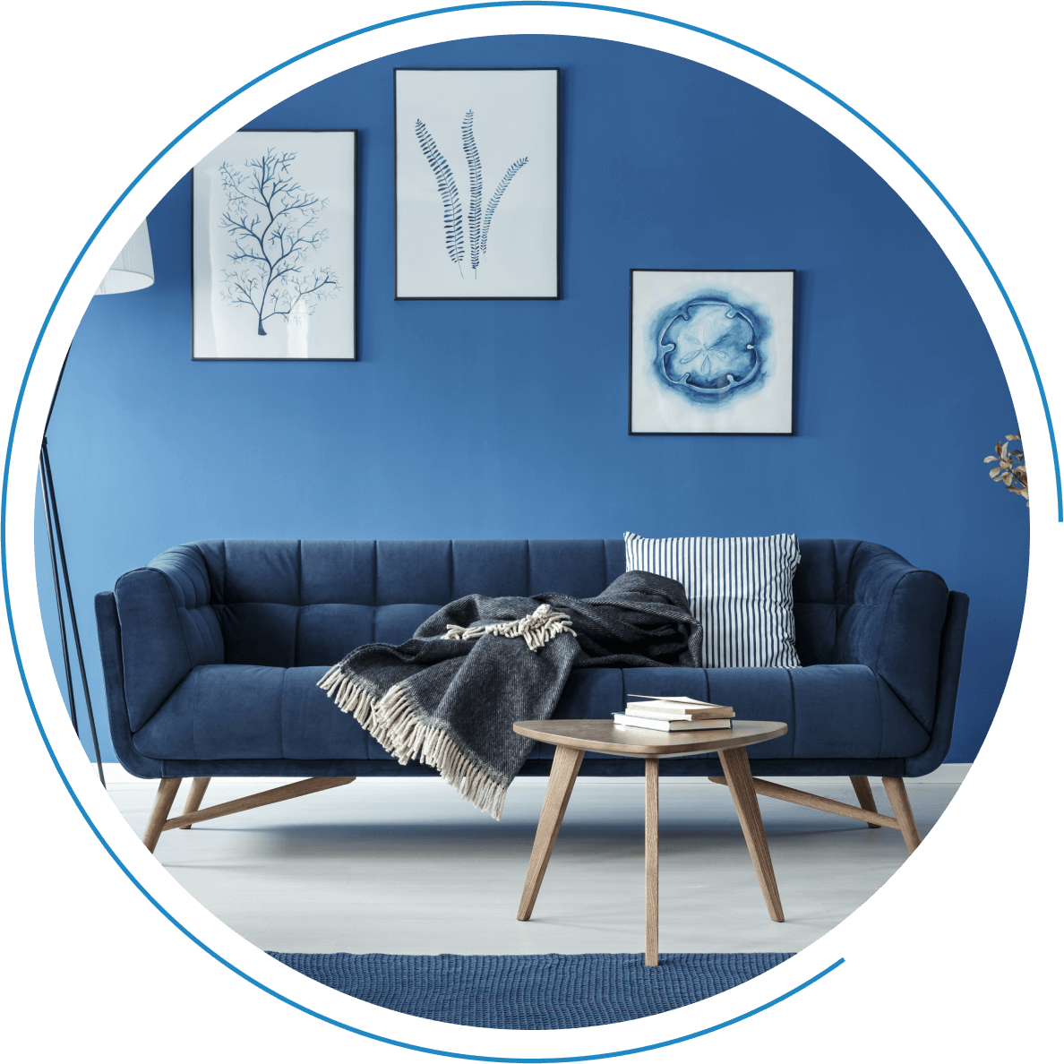 Blue living room with navy sofa and art.