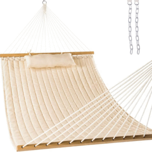 Beige fabric hammock with wooden spreader bars and pillow for outdoor relaxation.